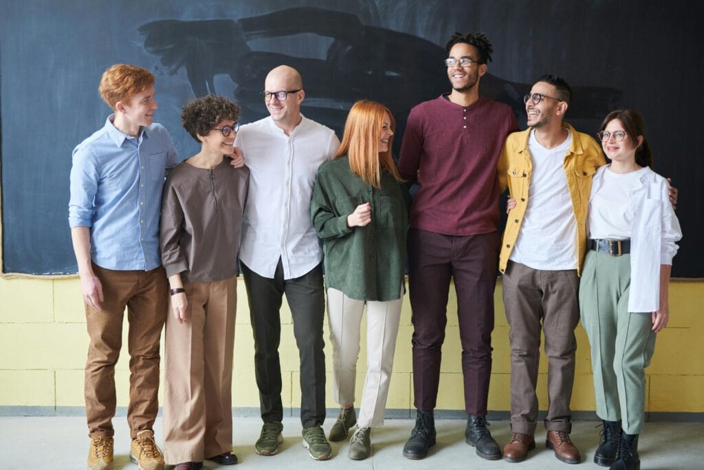 pexels-photo-3184394-3184394 A multicultural group of six adults standing happily together in a casual setting.