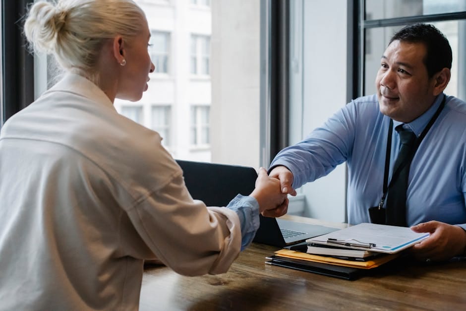 pexels-photo-5668859-5668859 Ethnic male entrepreneur shaking hand of female candidate during job interview in business company